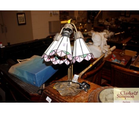 A Tiffany style three light table lamp on lily pad base