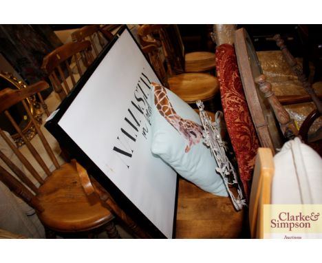 A poster print "Namastay in Bed"; a cushion decorated with a giraffe and "A Love" plaque