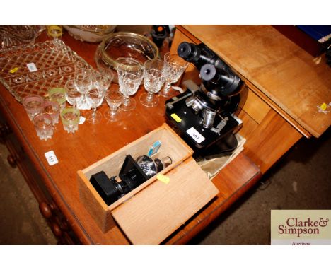 A Leitz microscope and a small boxed students microscope 