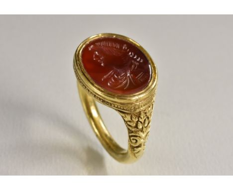 A Romanesque seal stamp ring, intaglio cut with a portrait of a gentleman, yellow metal Neoclassical shank, size U, 14.6g gro