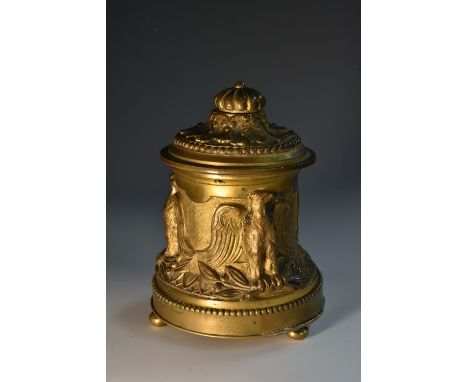 A 19th century ormolu inkwell, cast in relief with eagles, hinged cover, bun feet, 13cm high, c.1860