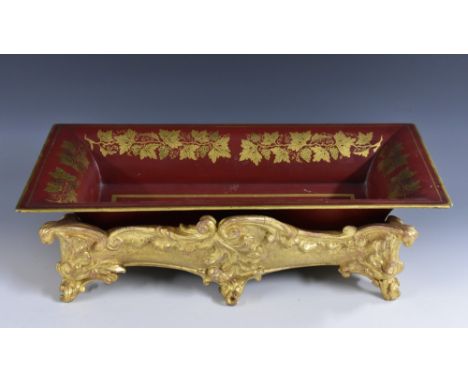 A 19th century giltwood and gesso table trough, carved and moulded with scrolling acanthus, the toleware liner printed in gil