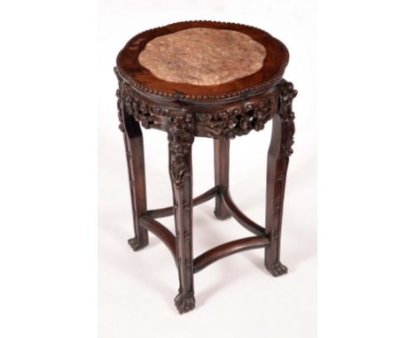 A Chinese padouk wood jardiniere stand, lobed circular top with inset soapstone panel, beaded border, the frieze and legs pie