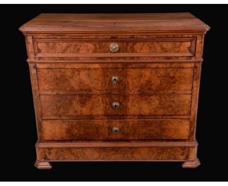 A Biedermier walnut canted rectangular commode, moulded top above four long graduated drawers, skirted base with a further dr