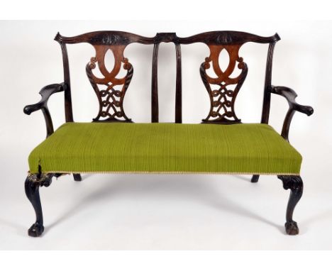 An Irish Chippendale design mahogany chair back sofa, cupid bow cresting rails, shaped and pierced splats, serpentine arms te