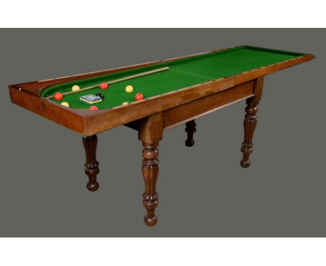 A William IV/early Victorian mahogany bagatelle table, folding top, turned and fluted legs, 91cm high, 121cm wide (folded) c.