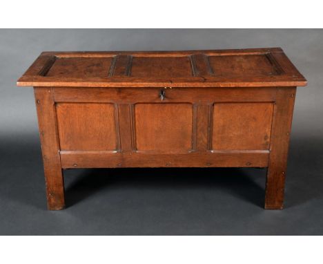 An 18th Century oak three panel blanket chest, hinged top, stile feet, 70cm high, 125cm wide, c.1720