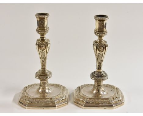 A pair of 18th century Dutch silver canted square table candlesticks, of seamed construction, cast and chased with portrait b