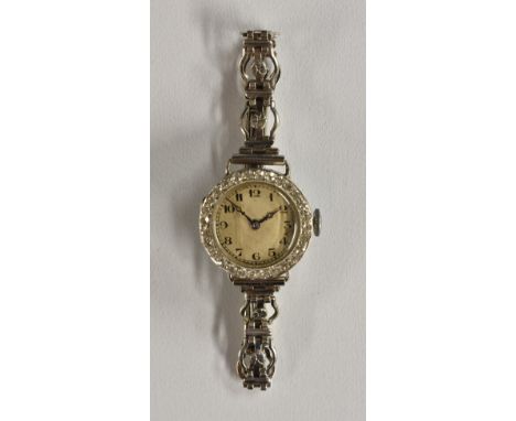 A Sanders Kensington diamond set cocktail watch, silver dial, Arabic numerals, ornate white metal case inset with a band of t