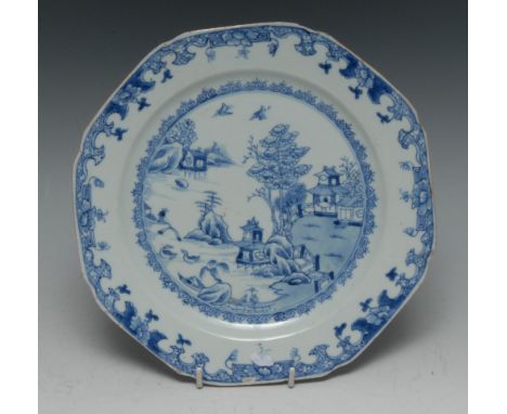 A Chinese octagonal plate, decorated in underglaze blue with pagoda and trees, elaborate scroll border, 22cm wide, early 19th