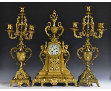 A 19th century French gilt metal mantel clock, 8.5cm circular enamel dial inscribed with Arabic numerals and painted with swa