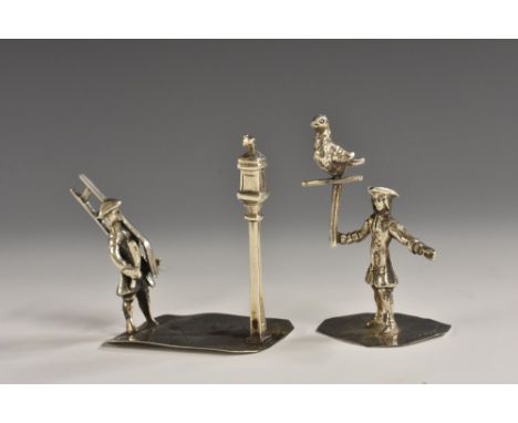 A Dutch silver toy figure, of a lamp lighter, he stands, holding his ladder, canted rectangular base, 4.5cm high; another (2)