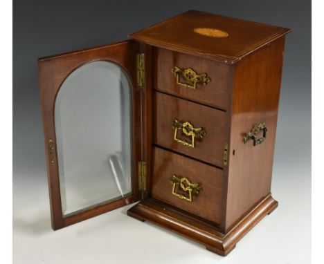 An Edwardian mahogany and marquetry table cabinet, oversailing rectangular top inlaid with an oval batwing patera, above a gl