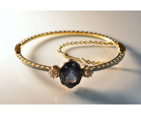 Carlo Giuliano - a late 19th century enamelled dark blue spinel and diamond set hinge bangle, the central oval spinel measuri