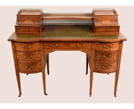 A Sheraton revival mahogany and marquetry Carlton House desk, the superstructure with a pair of hinged concave compartments a