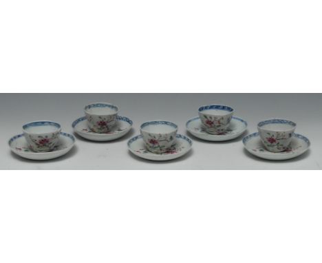 A set of five Chinese famille rose shaped tea bowls and saucers, decorated with peony and song bird, cobalt blue trellis bord