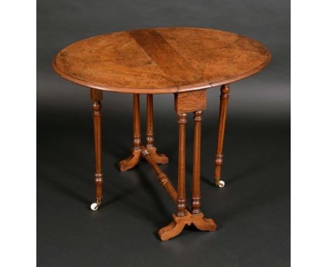 A Victorian burr walnut oval Sutherland table, by Edwards &amp; Roberts, paper label, well figured top, turned and reeded leg