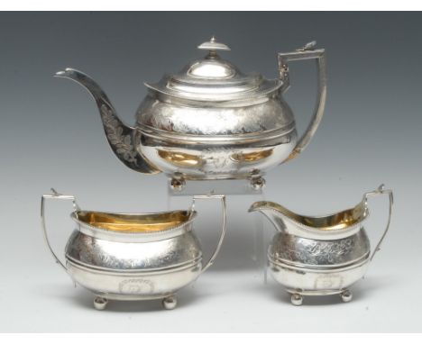 A George III Provincial silver three piece boat shaped tea service, comprising teapot, milk jug and sugar basin, each bright-