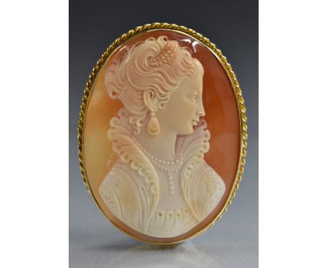 A carved shell cameo pendant brooch, oval panel carved as a classical Maiden, ruffled collar, flowing dress, mounted in an 18