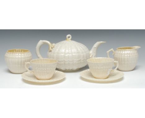 A Belleek Tridacna tete a tete, comprising  teapot and cover, milk jug, sugar bowl, two teacups and saucers, coral handles, w