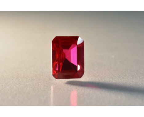 A loose rectangular emerald cut corundum ruby, measuring 11.68mm x 8.85mm x 6.50mm, calculated stone weight 8.03ct, clarity V