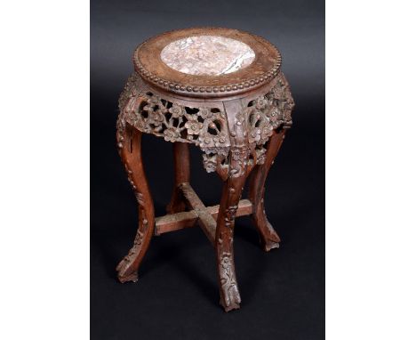 A Chinese hardwood jardiniere stand, circular top with inset soapstone panel, beaded border above a deep frieze pierced and c