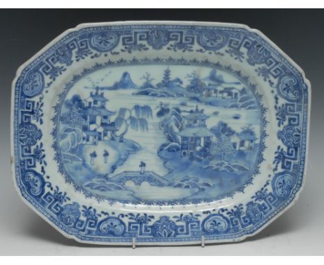 A Chinese canted rectangular meat plate, decorated in tones of underglaze blue with figures in a monumental landscape of pago