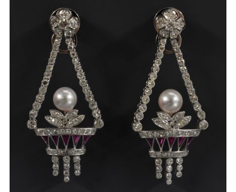 A pair of Belle Epoque style diamond and ruby chandelier earrings, each as a basket crested by a pearl, each fitting for pier