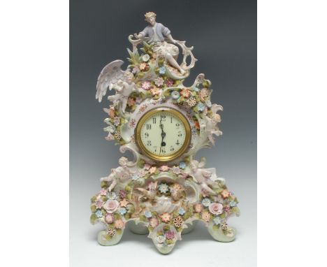 A large German porcelain mantel clock, the 9.5cm dial with Arabic numerals, the elaborate scroll case encrusted with flowerhe