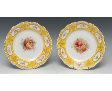 A pair of Royal Worcester shaped circular plates, painted by Ricketts, signed, the centre painted with ripe fruit, the rim wi