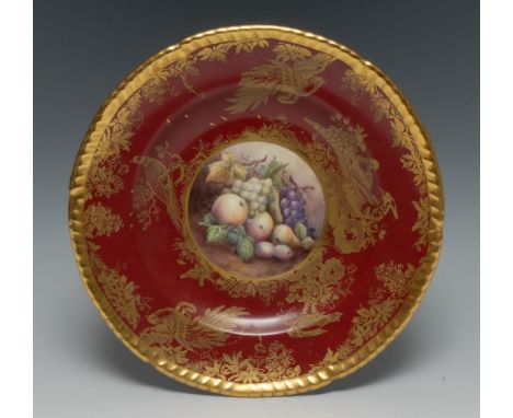 An English Porcelain shaped circular plate, painted by Stefan Nowacki, signed, with ripe fruit, within a gilt cartouche on a 