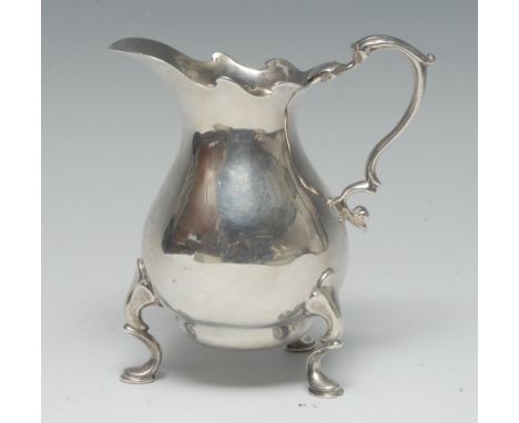 A George II silver bellied cream jug, of usually substantial gauge, shaped rim, acanthus-capped double-scroll handle, pad fee