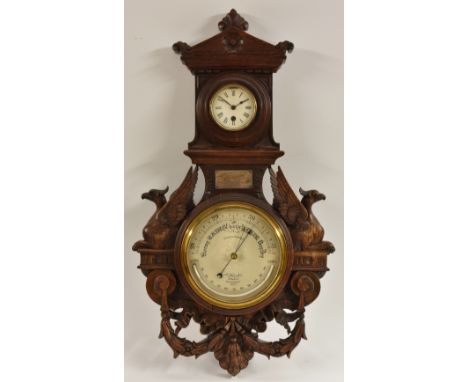 A late Victorian oak wall aneroid barometer, with alcohol thermometer and clock, signed J. Hicks/maker/London /8090, the baro