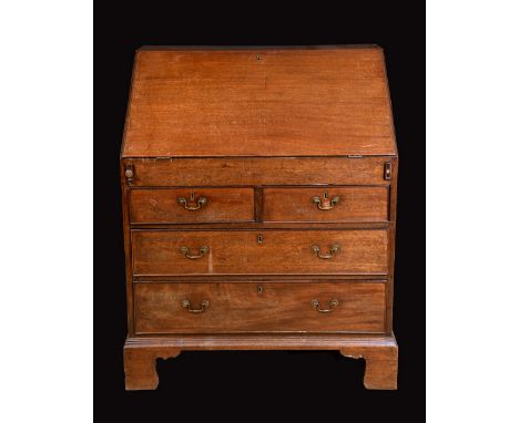 A George III mahogany bureau, of unusual proportions, fall front enclosing a fitted interior above two short and two long gra