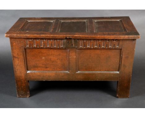 A Charles II oak blanket chest, hinged three panel top, two panel front with nulled frieze, stile feet, 67cm high, 115cm wide