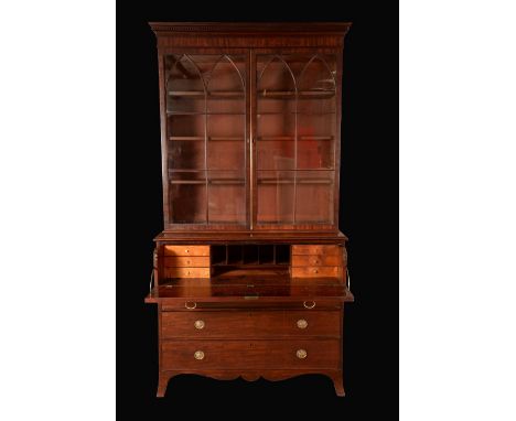 A George III mahogany secretaire library bookcase, dentil cornice above a pair of rectangular doors with pointed arched glazi