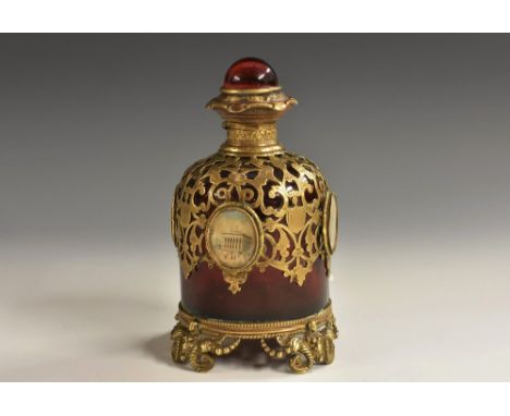 A 19th century French Palais-Royal gilt-metal mounted ruby glass scent bottle, the sides adorned with topographical vignettes