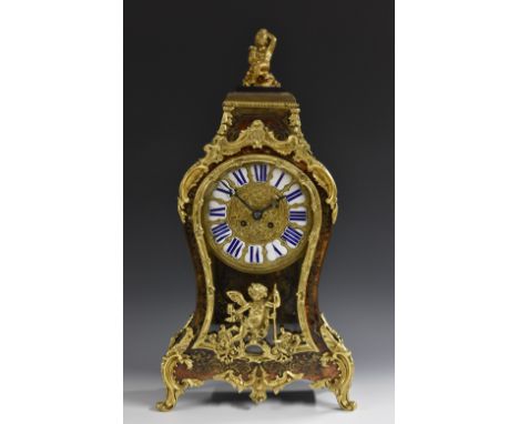 A Napoleon III gilt metal mounted boulle cartouche shaped mantel clock, 15cm dial inscribed upon enamel cartouches with Roman