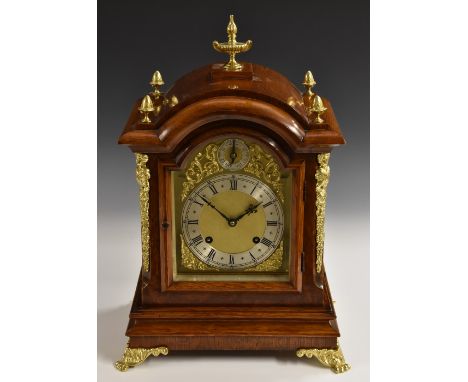 A late 19th century gilt metal mounted oak bracket clock, 15cm arched brass dial with silvered chapter ring inscribed with Ro