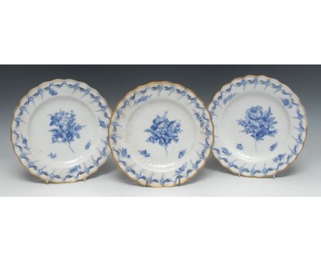 A set of three 18th century Royal Copenhagen plates, painted in underglaze blue with peony and other flowers, pierced border 
