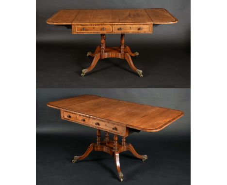 A pair of Regency rosewood rounded rectangular sofa tables, each oversailing crossbanded tops above a pair of frieze drawers,