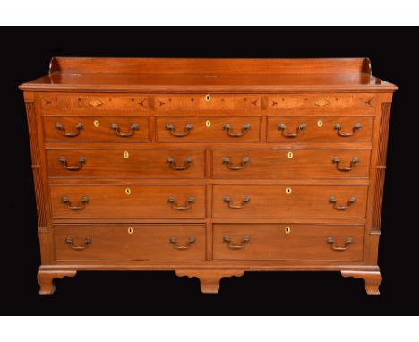 A George III mahogany Lancashire chest, shallow three-quarter gallery and hinged top above five blind and two pairs of cockbe