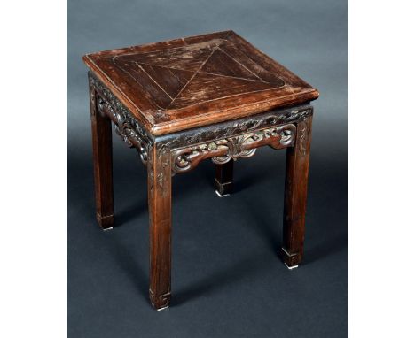 A Chinese padouk wood rectangular jardiniere stand, panel top above a deep frieze pierced and carved with scrolls, square leg