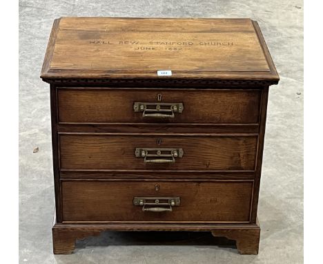 An oak chest of three drawers, constructed from a pew from Stanford Church. 25½" wide