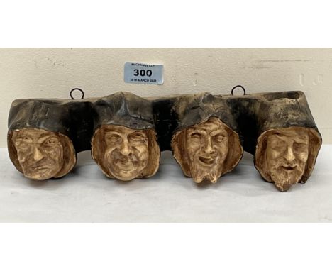 An early 20th century German plaster mural pipe rack. 11" wide