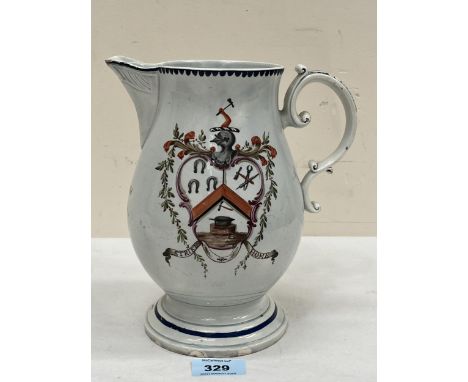 A George III Staffordshire pearlware pitcher, decorated with a trade armorial and flower spray. Inscribed with a name and dat