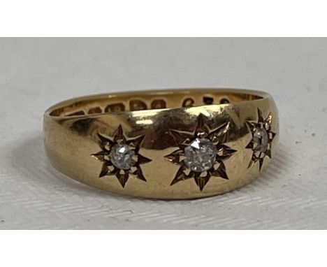 A three stone gypsy set ring. In gold marked 18. 4g gross. Size L