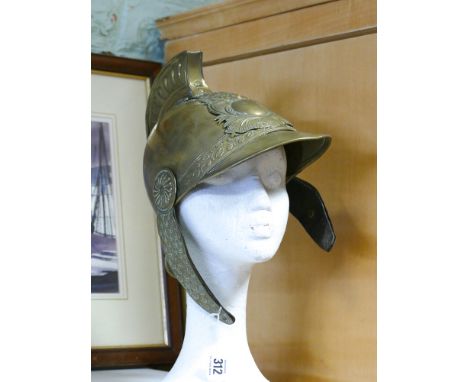 French brass Fireman's helmet from the town of D'Aisy complete with its chin straps and helmet plate