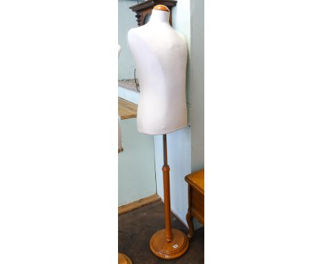 Half male shop mannequin on light oak stand