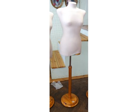 Half female shop mannequin on light oak stand 